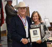 Amy Farmer Accepting Plaque for her Dad